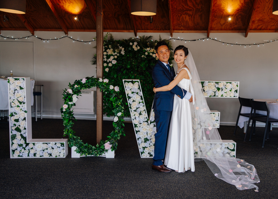 asian newlyweds in venue by LOVE decor